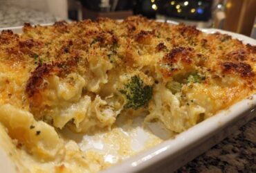 Close-up of a baked Chicken Divan casserole with a crispy, golden breadcrumb topping and creamy filling showing chicken and broccoli.