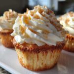 Close-up of a delicious banana pudding cupcakes topped with whipped cream frosting and crushed wafers.