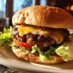 Close-up of a delicious Air Fryer Turkey Burgers stacked with lettuce, tomato, and melted cheese on a toasted bun.