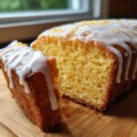 Close-up of a sliced Copycat Starbucks Iced Lemon Loaf showing the moist crumb and thick white lemon glaze.