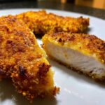 Close-up of perfectly cooked Crispy Air Fryer Pork Chops, showing the golden crust and juicy white interior.