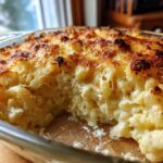 Close-up of creamy Keto Cauliflower Mac and Cheese with a bubbly, browned cheese crust.