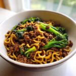 Close-up of One-Pot Beef and Broccoli Ramen Noodles with ground beef and vibrant green broccoli florets.