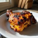 Close-up of a perfectly cooked Spicy Honey Garlic Air Fryer Chicken Thigh with a caramelized, slightly charred glaze.