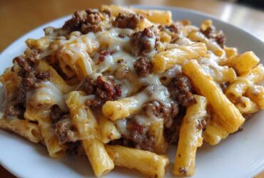 A close-up of Cheesy Ground Beef Pasta with Garlic Cream Sauce, featuring ziti pasta topped with savory ground beef and melted mozzarella cheese.