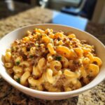 Close-up of a white bowl filled with Cheesy Taco Pasta One Pot Dinner Idea, featuring elbow macaroni, seasoned ground meat, and creamy cheese sauce.