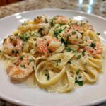 Close-up of creamy Garlic Butter Shrimp Alfredo Pasta topped with fresh parsley.