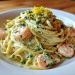 A close-up of rich Creamy Lemon Garlic Shrimp Pasta topped with fresh parsley and lemon zest.
