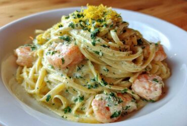 A close-up of rich Creamy Lemon Garlic Shrimp Pasta topped with fresh parsley and lemon zest.