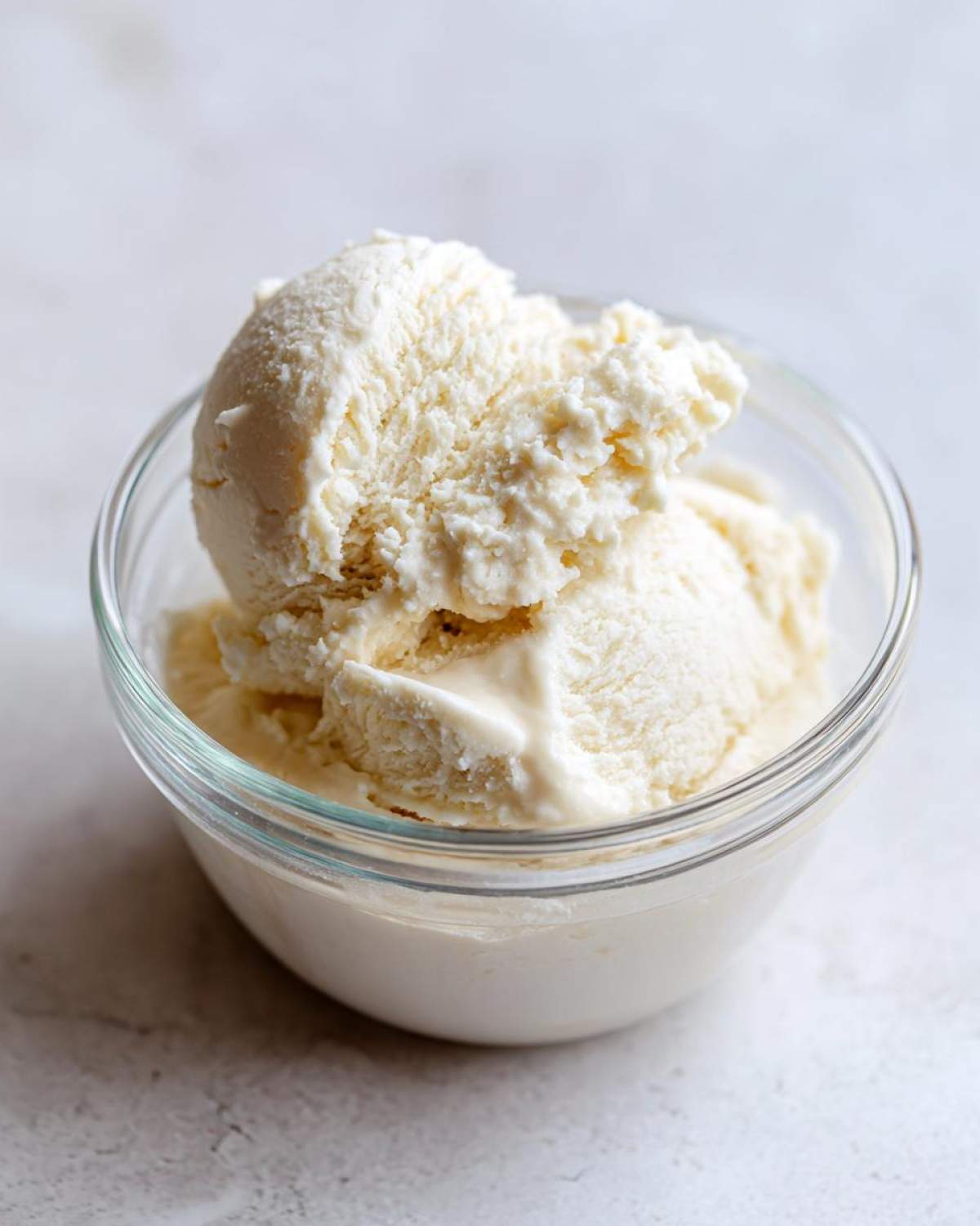 Close-up of two scoops of thick, creamy vanilla base resembling ice cream for a Creamy Vanilla Protein Smoothie Bowl.