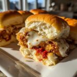 Close-up of Crispy Chicken Parmesan Sliders with melted mozzarella cheese on soft slider buns.