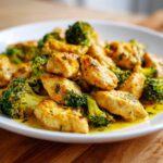 Close-up of tender chicken pieces and bright green broccoli florets coated in a rich garlic butter sauce in Garlic Butter Chicken and Broccoli Stir Fry.