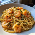 Close-up of Garlic Butter Shrimp with Pasta coated in a creamy sauce and topped with fresh parsley.