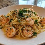 Close-up of Garlic Butter Shrimp Pasta with Lemon Flavor, featuring linguine tossed in butter sauce with plump shrimp and fresh parsley.