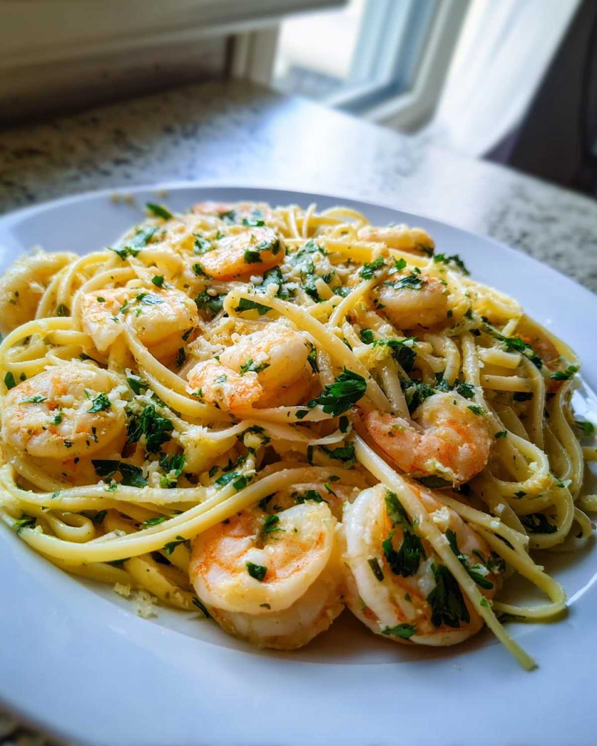 Close-up of Garlic Butter Shrimp Pasta with Lemon Flavor, featuring linguine, plump shrimp, and fresh parsley.