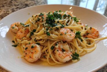 Close-up of Garlic Butter Shrimp Pasta with Lemon Flavor, featuring linguine tossed in butter sauce with plump shrimp and fresh parsley.