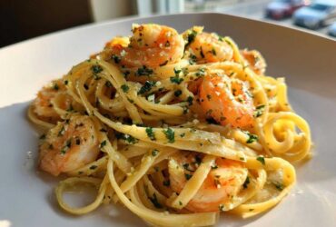A close-up of delicious Garlic Butter Shrimp with Pasta tossed in a rich, buttery sauce and topped with fresh parsley.