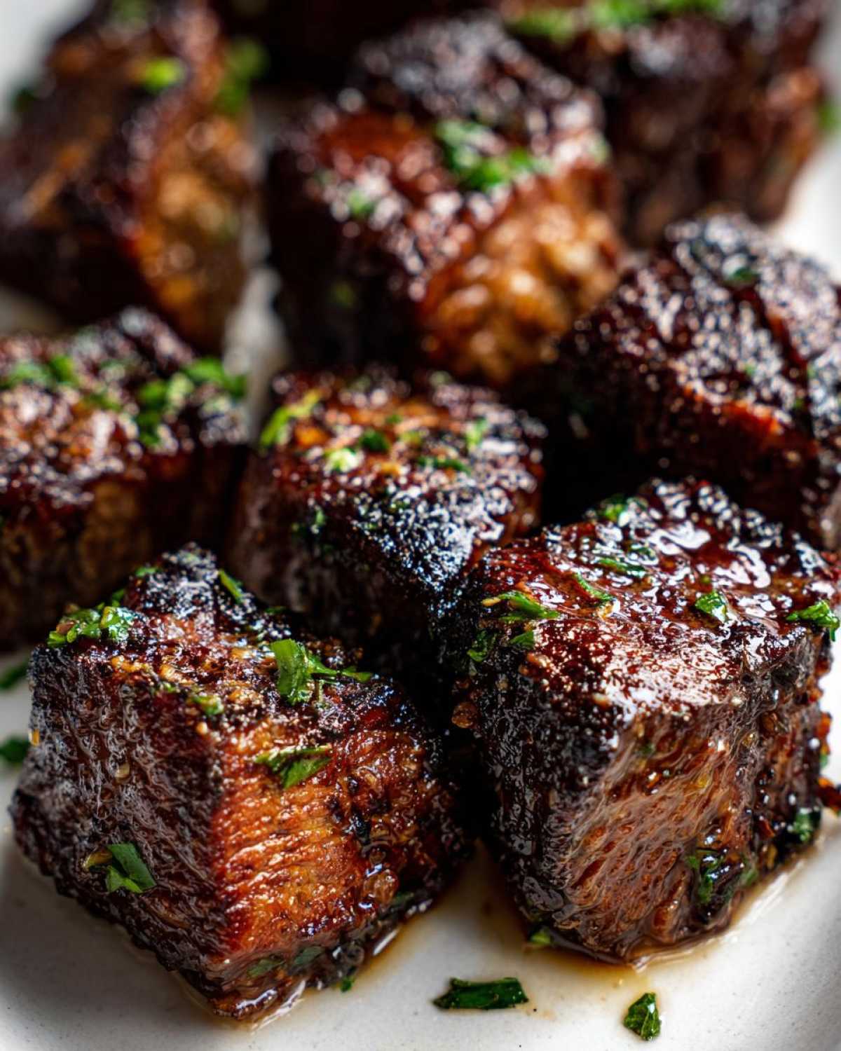 Close-up of rich, caramelized Garlic Butter Steak Bites with crispy edges, garnished with fresh parsley.