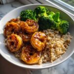 Close-up of a Honey Garlic Shrimp Bowl Quick Dinner with glazed shrimp, brown rice, and steamed broccoli.