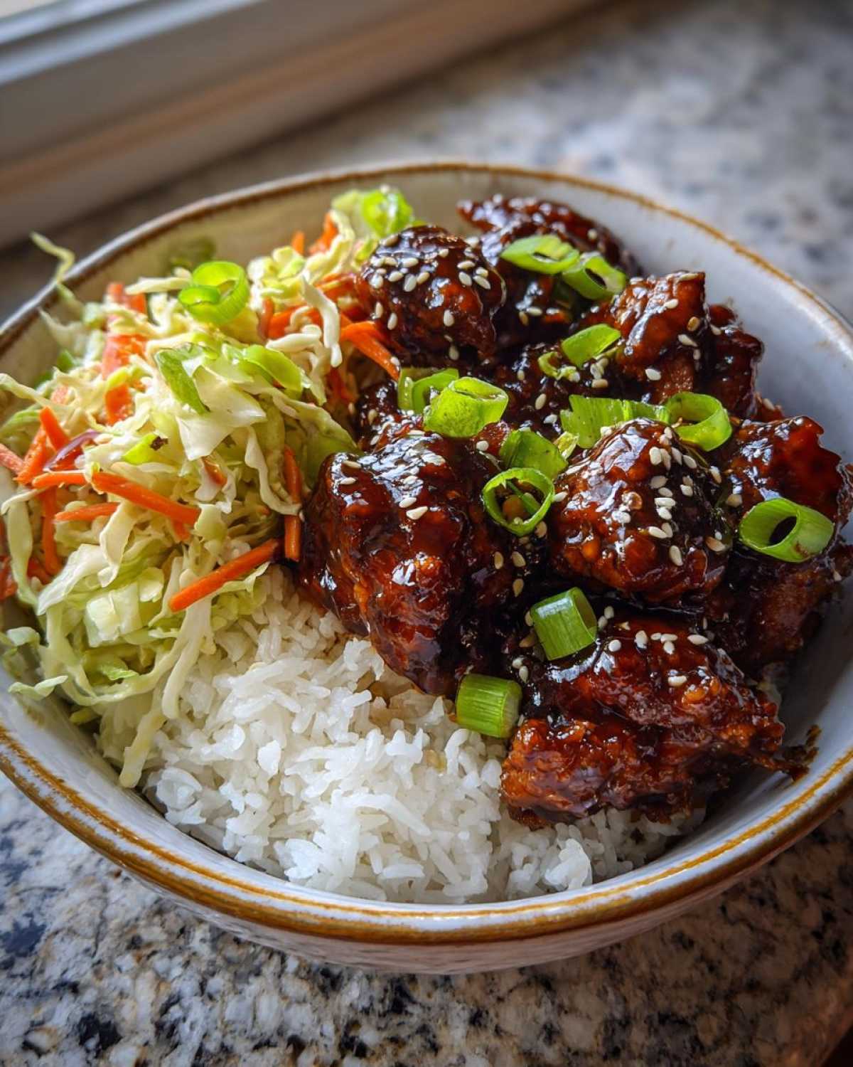 Close-up of a Sticky BBQ Chicken Bowl with Rice, featuring glazed chicken, white rice, and coleslaw.