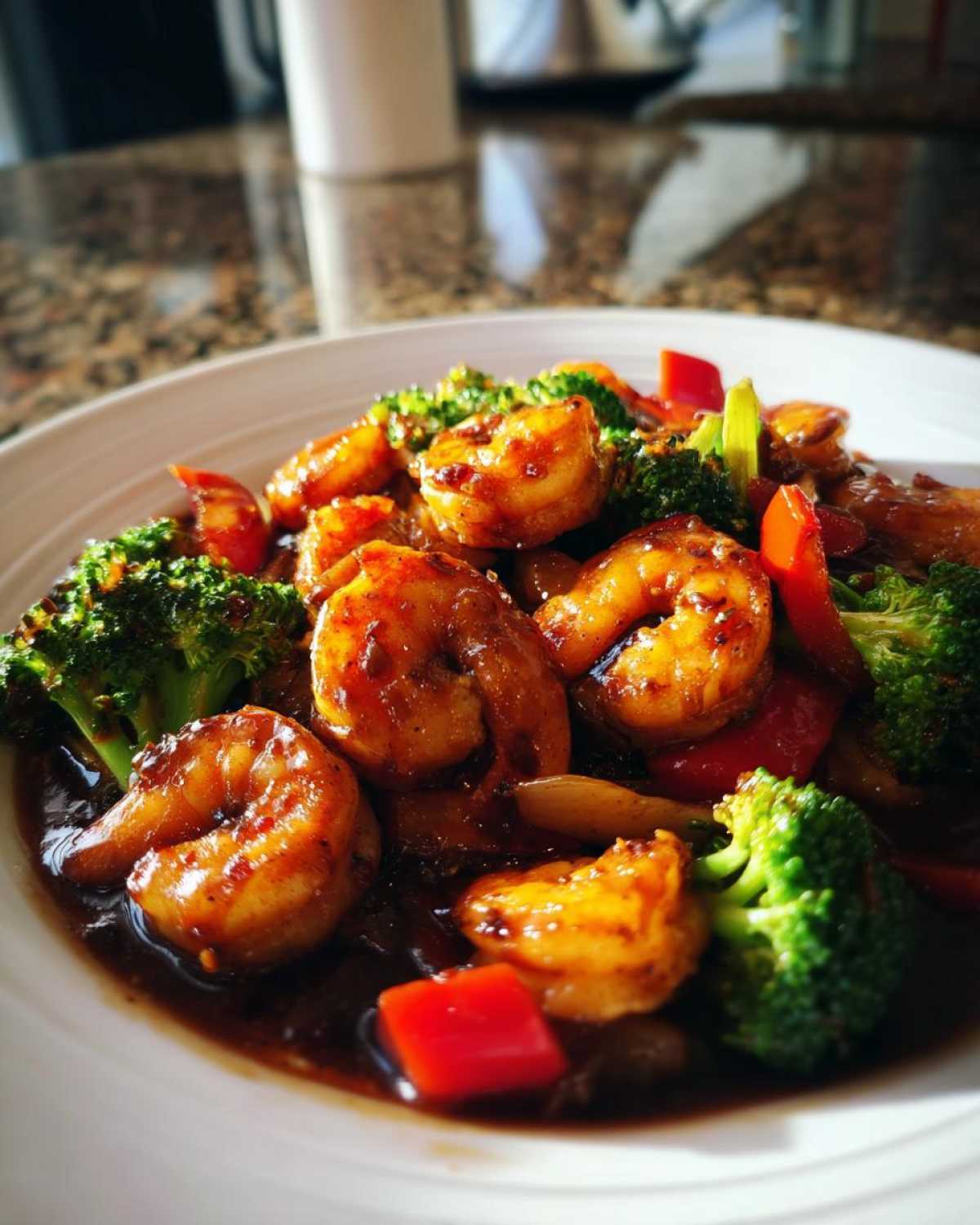 Close-up of glazed shrimp and bright green broccoli florets in a Sticky Teriyaki Shrimp Stir Fry Quick Meal.