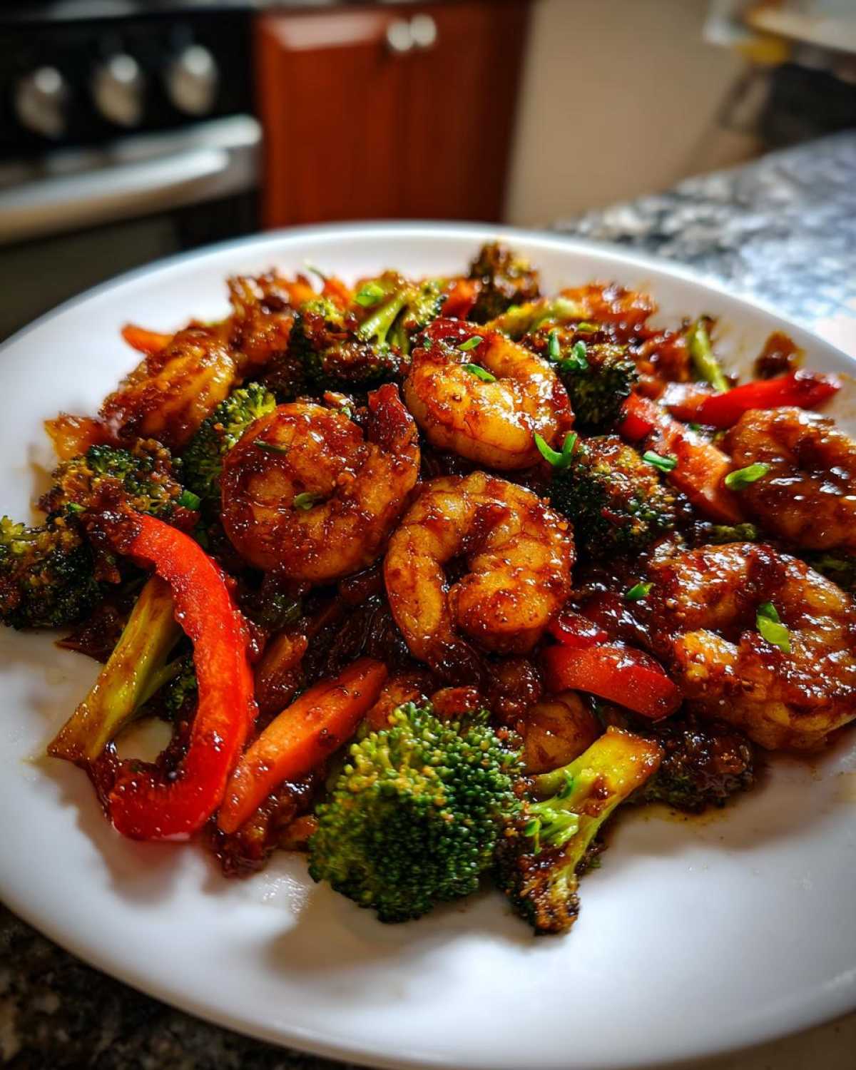 Plated Sticky Teriyaki Shrimp Stir Fry Quick Meal featuring glossy shrimp, broccoli florets, and red bell pepper strips.